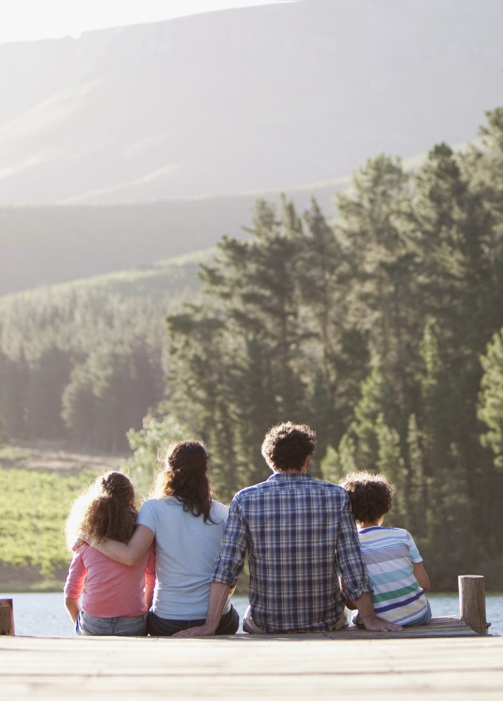 family on a dock in the mountains